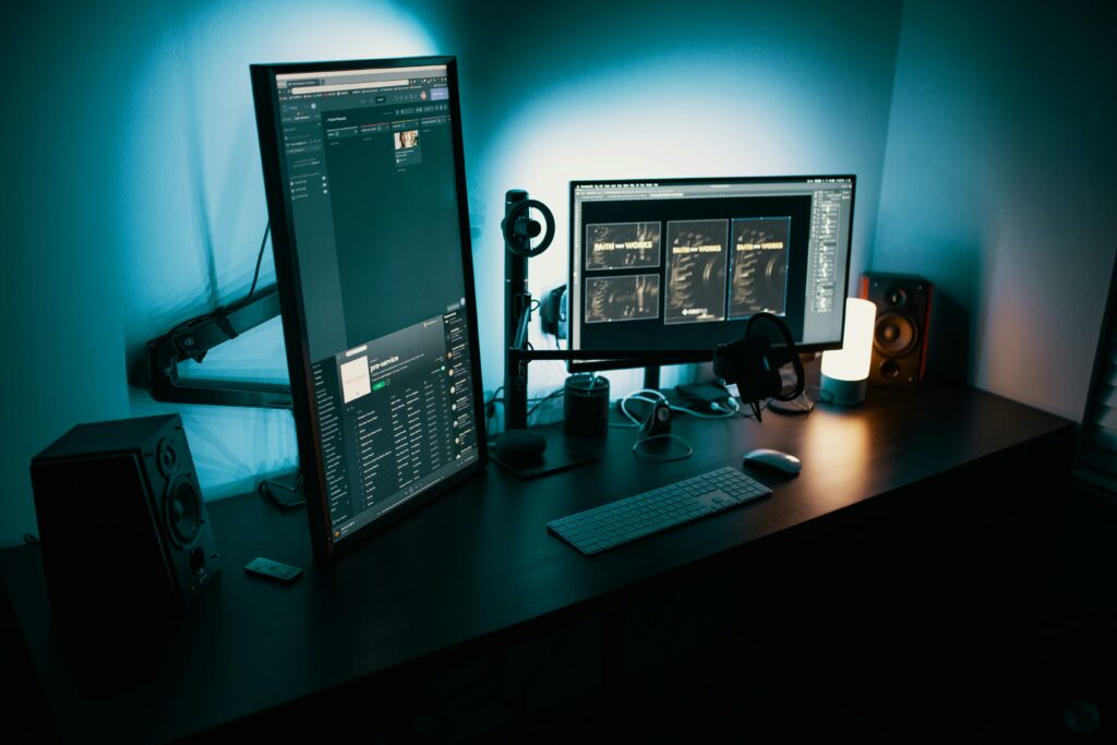 Laptop with accessories including keyboard, mouse, and notebook on a clean desk